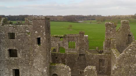 Aerial-orbit-of-old-broken-monastic-settlement-walls-of-Bective-Abbey-on-bright-day