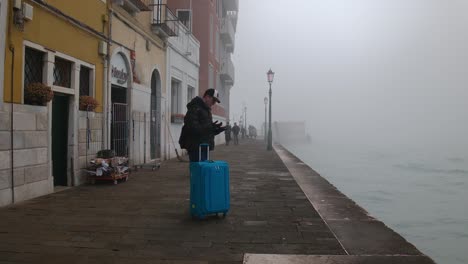 Misty-Venetian-Walkway-with-lost-tourist-Traveler-amidst-locals