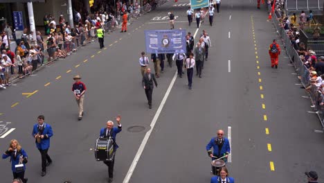Military-service-people-from-the-38-Squadron-Association,-Royal-Australian-Air-Force-uniformly-marching-down-the-street,-participating-Anzac-Day-parade,-handheld-motion-shot