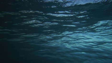 Vista-Trasera-Desde-Detrás-De-La-Superficie-De-Agua-Del-Océano-Con-Textura-Gruesa-Mientras-Choca-Contra-La-Ola,-Cámara-Lenta