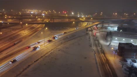 Aerial-view-shows-snow-plows-at-work-during-heavy-snowfall-on-highways-in-Montreal