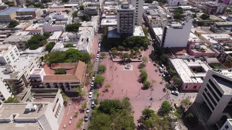 Red-place,-Parque-Bolivar-in-city-Santa-Marta,-Colombia,-aerial-orbit,-sunny-day