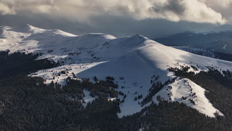 Cornice-Vail-Pass-Colorado-Rocky-Mountain-backcountry-high-altitude-ski-snowboard-backcountry-avalanche-terrain-peaks-sunlight-on-forest-winter-spring-snowy-peaks-evening-clouds-sunset-forward-pan-up