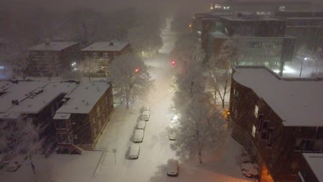 A-bird's-eye-view-of-the-downtown-streets-covered-in-a-blanket-of-snow-at-night
