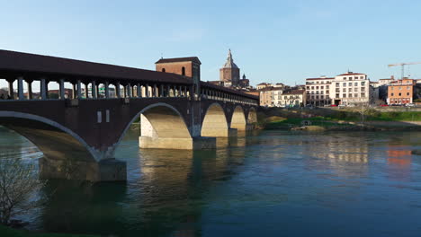 Skyline-of-Ponte-Coperto-bridge-is-over-the-Ticino-river-and-Pavia-Cathedral-background