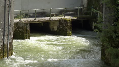 Water-flows-out-of-a-hydropower-plant,-weir