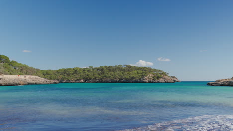 Scenic-view-of-Cala-Mondrago-beach-in-Mallorca-with-clear-turquoise-waters