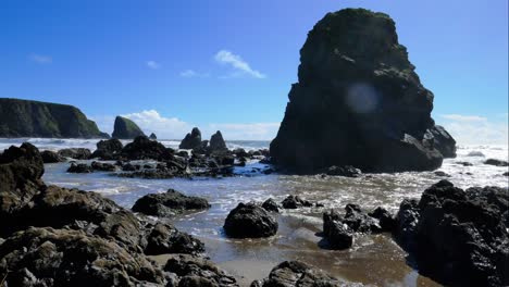 Timelapse-sea-stack-s-blue-sky-and-moving-clouds-incoming-tide-Ballydwane-Copper-Coast-Waterford-Ireland