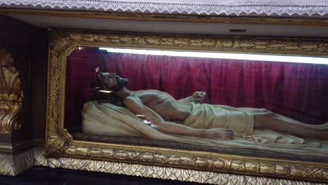 Body-of-dead-jesus-christ-with-european-beard-naked-inside-coffin-dead-Catholic-representation-in-San-jose-de-Flores-basilica-of-Buenos-Aires-Argentina