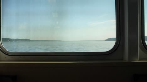 Ferry-interior-with-empty-rows-of-seats-on-a-sunny-day