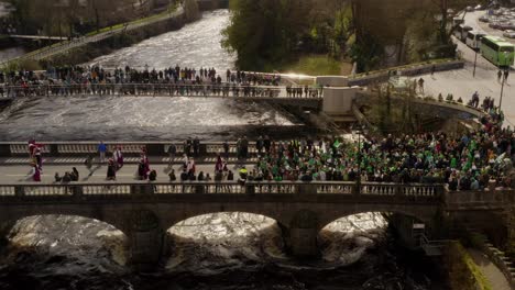 Parade-marchers-carry-Ukranian-flag-across-bridge-during-Saint-Patrick's-Day-on-River-Corrib