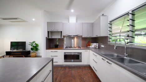 Modern-Luxury-Kitchen-dolly-along-island-with-grey-and-stainless-steel-cabinets-and-chopping-block