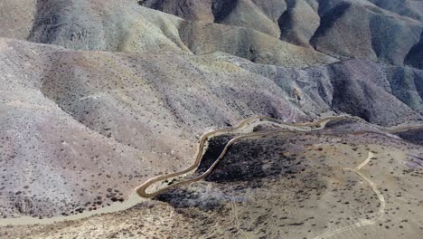 Dirt-road-contours-remote-undeveloped-arid-hillsides-in-rural-Chile