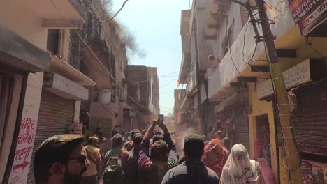 pov-shot-Many-men-are-blowing-paint-from-above-the-house-and-walking-towards-the-temple