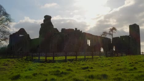 Sun-shines-on-Bective-Abbey-backlit-light-outlines-old-monastic-settlement-walls-in-Ireland