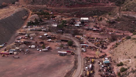 Aerial-View-of-Jerome-Ghost-Town,-Abandoned-Mine-Buildings-and-Vehicles,-Arizona-USA