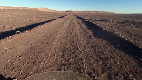 POV-as-motorcycle-drives-on-rough-desert-dirt-road-in-Atacama-Chile