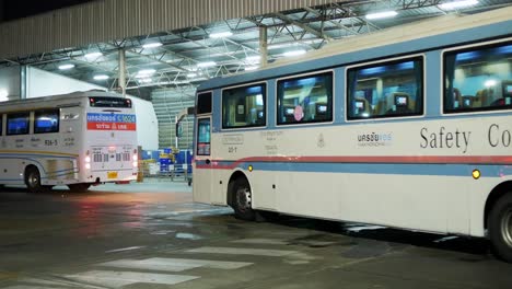 Buses-are-queuing-at-a-platform-in-front-of-a-warehouse-where-cargoes-are-stored-at-a-bus-terminal-in-Bangkok,-Thailand