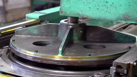 Secured-on-a-rotary-table,-drum-lids-undergo-a-precise,-automated-machining-process