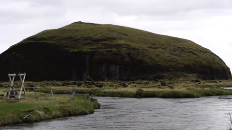River-and-Volcanic-Hill-on-Humid-Day-in-Landscape-of-Iceland