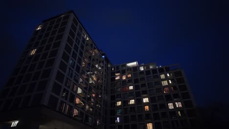 Pov-of-residential-apartment-block-at-night-low-angle-wide-shot-in-twilight