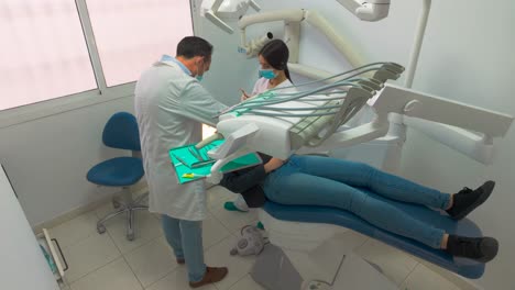 High-angle-wide-shot-of-woman-removing-tooth-at-the-dentist