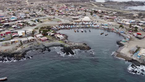 Aerial-orbits-protected-fishing-harbour,-Caleta-Chanaral,-Chile-coast