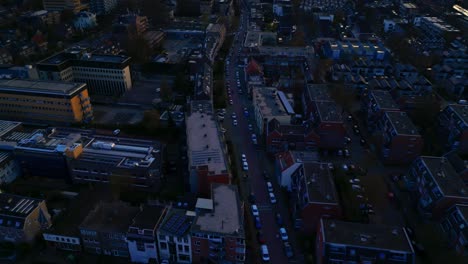 Arnhem-by-night-Dutch-top-down-city-drone-twilight-shot-with-tilt-up