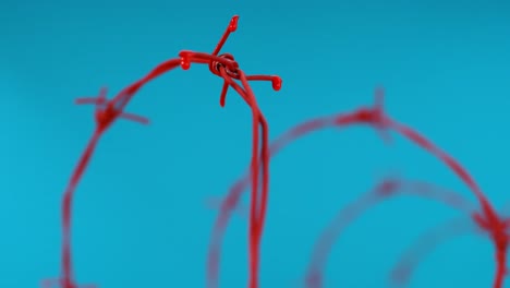Red-liquid-droplets-fall-from-barbed-wire-against-a-blue-backdrop,-symbolizing-artistic-expression