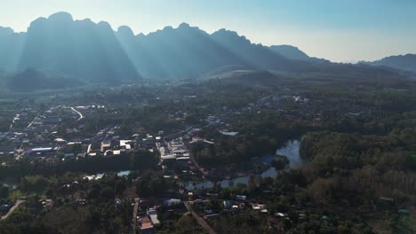 A-breathtaking-view-of-Sangklaburi-and-its-rural-landscape-reveals-towering-mountains-and-sun-flares-illuminating-the-valley