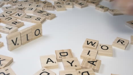Diagonal-close-up:-Word-VIOLENCE-made-with-Scrabble-game-tile-letters