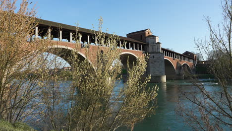 Panorama-of-Ponte-Coperto-is-a-bridge-over-the-Ticino-river-in-Pavia-at-sunny-day,-Lombardy,-Pavia,-Italy
