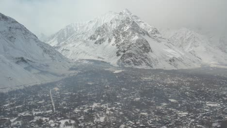 Drone-shot-of-mountains-of-Skardu-with-city-at-foreground-in-Pakistan