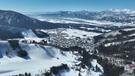 Aerial-static-shot-of-Japans-Nozawaonsen-Mountain-Ski-Resort-Village