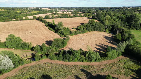 Downward-Tilt-Dolly-Aerial-of-Field-With-Hay-Bales-in-France