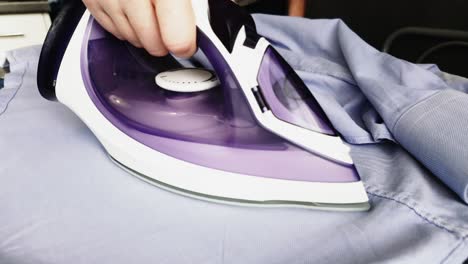 Male-Hands-Ironing-Clothes-With-Iron-On-The-Board-With-Steam-Video