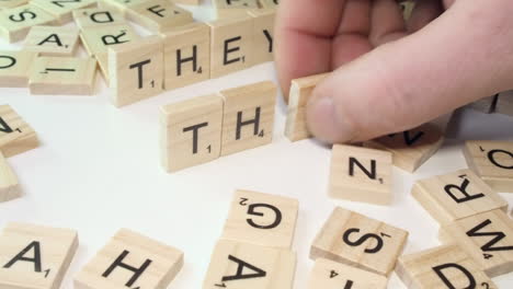 Closeup:-Pronoun-words-THEY-and-THEM-formed-on-table-with-letter-tiles