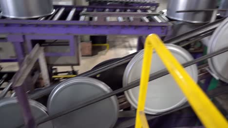 Steel-drum-lids-travel-steadily-on-a-conveyor-for-further-processing