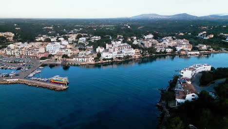 Serene-dusk-view-over-Portopetro-harbor,-Mallorca,-calm-sea,-and-boats