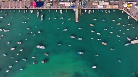 Aerial-top-down-shot-of-fishing-boat-anchored-in-the-bay
