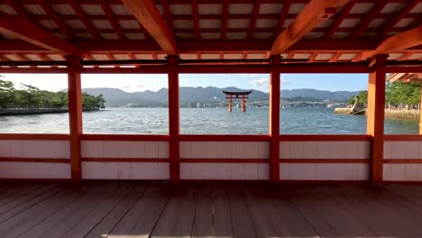 Observing-from-the-wooden-promenade-at-Itsukushima-Shrine's-Grand-Torii-Gate-in-Hiroshima,-Japan,-encapsulates-the-spirit-of-cultural-exploration-and-travel