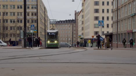 Public-transit-train-rolls-to-stop-on-street-in-downtown-Helsinki