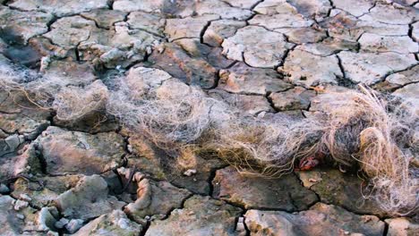 Dürre-Verlassenes-Fischernetz-Auswirkungen-Des-Klimawandels-Rissige-Erde-Boden