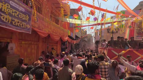pov-shot-Many-people-are-going-to-the-temple-where-colors-are-flying-and-many-more-people-are-sitting-around