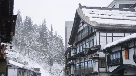 Snow-Covered-Eaves-of-Ryokans-in-Mountains-of-Ginzan-Onsen,-Yamagata-Japan