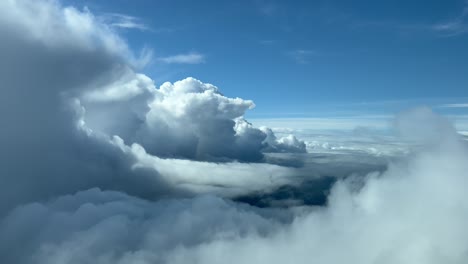 Unique-immersive-pilot-POV-in-a-real-flight-across-a-stormy-sky-with-some-cumulonimbus-in-a-sunny-day-and-a-deep-blue-sky