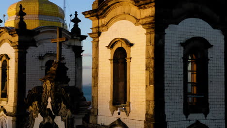 Aerial-view-of-Nosso-Senhor-do-Bonfim-church,-the-city-around-and-the-ocean-at-background,-Salvador,-Bahia,-Brazil