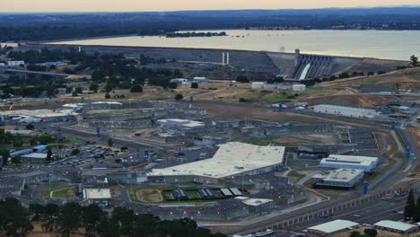 Aerial-Drone-View-of-Folsom-Prison-to-reveal-Folsom-Lake,-during-sunset