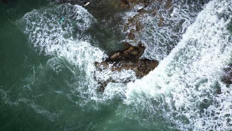 waves-crashing-by-the-seashore-on-stormy-day-aerial-drone-view-of-wild-beach-in-the-coastline-of-Spain