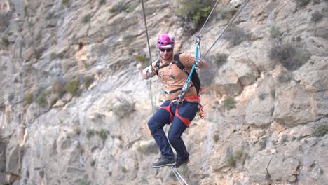 Group-of-friends-do-Via-Ferrata-climb-mountain-with-safety-equipment-in-Cartagena,-Region-of-Murcia,-Spain